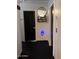 Hallway with black doors, a modern mirror, and black floors at 21570 N Greenway Rd, Maricopa, AZ 85138
