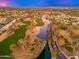An aerial view showcases the community's golf course, lake, and lush landscaping at 2226 W Periwinkle Way, Chandler, AZ 85248
