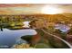 Picturesque aerial view of golf course, community and lake during sunset at 2226 W Periwinkle Way, Chandler, AZ 85248