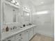 Bright bathroom with double vanity, large mirrors, and walk-in shower at 2226 W Periwinkle Way, Chandler, AZ 85248