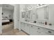 Bathroom with double vanity, decorative lighting, and access to main bedroom at 2226 W Periwinkle Way, Chandler, AZ 85248
