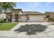 A single-story home with a neutral color palette, multi-car garage, and a tile roof at 2226 W Periwinkle Way, Chandler, AZ 85248