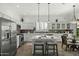 Modern kitchen with stainless steel appliances, center island, white cabinets, breakfast nook, and tiled backsplash at 2226 W Periwinkle Way, Chandler, AZ 85248