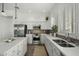Bright kitchen with stainless steel appliances, modern white cabinetry, and sleek countertops at 2226 W Periwinkle Way, Chandler, AZ 85248