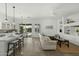 Open-concept living room featuring a kitchen with an island and backyard access through a sliding glass door at 2226 W Periwinkle Way, Chandler, AZ 85248