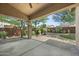 Large covered patio area with ceiling fan and mature landscaping in backyard at 2226 W Periwinkle Way, Chandler, AZ 85248
