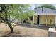 View of the home's backyard, featuring a covered porch and mature trees at 227 N Morris --, Mesa, AZ 85201