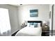 Comfortable bedroom with a white comforter, blue pillows, bedside tables, and neutral decor for a peaceful retreat at 227 N Morris --, Mesa, AZ 85201