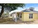 Side exterior shot of a yellow home with an outdoor seating area at 227 N Morris --, Mesa, AZ 85201