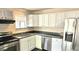 Bright kitchen featuring modern stainless steel appliances, granite countertops, and white cabinetry at 227 N Morris --, Mesa, AZ 85201