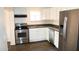 Well-appointed kitchen with stainless steel appliances, ample cabinet space, and laminate floors at 227 N Morris --, Mesa, AZ 85201