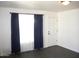 Inviting living room featuring dark laminate floors, neutral walls, and natural light at 227 N Morris --, Mesa, AZ 85201