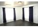 Comfortable living room space with dark laminate flooring and neutral decor at 227 N Morris --, Mesa, AZ 85201