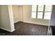 Bright, open area with laminate flooring, a large window, and convenient access to other rooms at 227 N Morris --, Mesa, AZ 85201
