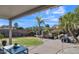 Backyard featuring manicured landscaping, a rock water feature, and mature palms under a blue sky at 2302 E Paraiso Dr, Phoenix, AZ 85024
