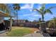 Spacious backyard with well-maintained lawn and mature trees, with block fence surrounding the yard at 2302 E Paraiso Dr, Phoenix, AZ 85024