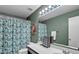 Bright bathroom features a shower curtain and large mirror at 2302 E Paraiso Dr, Phoenix, AZ 85024