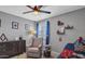 Cozy bedroom with unique decor, a comfortable chair, and ample natural light at 2302 E Paraiso Dr, Phoenix, AZ 85024
