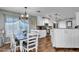 Light-filled dining area with wood table, seating for six, and kitchen view at 2302 E Paraiso Dr, Phoenix, AZ 85024