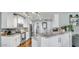 Bright kitchen featuring white cabinetry, granite countertops, stainless steel appliances, and wooden floors at 2302 E Paraiso Dr, Phoenix, AZ 85024