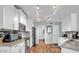 Bright kitchen featuring white cabinetry, granite countertops, stainless steel appliances, and wooden floors at 2302 E Paraiso Dr, Phoenix, AZ 85024