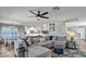 Open-concept living room features a large sectional, ceiling fan, and seamless flow to the kitchen at 2302 E Paraiso Dr, Phoenix, AZ 85024