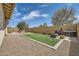 Spacious backyard featuring artificial grass, a brick perimeter, BBQ, and gravel at 23139 E Via Del Sol --, Queen Creek, AZ 85142