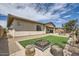 Charming backyard with green lawn, fire pit and logs, perfect for outdoor enjoyment at 23139 E Via Del Sol --, Queen Creek, AZ 85142