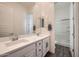 Clean bathroom with dual sinks, white cabinetry, large mirror, and tiled shower at 23139 E Via Del Sol --, Queen Creek, AZ 85142