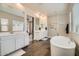 Beautiful bathroom featuring a soaking tub, walk-in shower, dual sinks, and wood-look tile floor at 23139 E Via Del Sol --, Queen Creek, AZ 85142