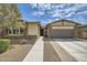 Charming single-story home with stone accents, a well-maintained yard, and a convenient two-car garage at 23139 E Via Del Sol --, Queen Creek, AZ 85142