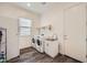 Bright laundry room with washer, dryer, sink, storage, and door to the exterior at 23139 E Via Del Sol --, Queen Creek, AZ 85142