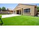 Backyard featuring artificial grass and a covered patio at 291 E Canyon Rock Rd, San Tan Valley, AZ 85143