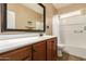 Clean bathroom featuring vanity with dark wood cabinets, white countertop and shower at 291 E Canyon Rock Rd, San Tan Valley, AZ 85143