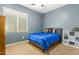 Cozy bedroom with carpet flooring, blue comforter, and natural light from the window at 291 E Canyon Rock Rd, San Tan Valley, AZ 85143
