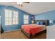 Cozy bedroom with blue walls, ceiling fan, two windows, and natural light at 291 E Canyon Rock Rd, San Tan Valley, AZ 85143