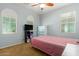Bright bedroom with carpet, pink quilt, window, and a dresser at 291 E Canyon Rock Rd, San Tan Valley, AZ 85143