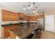 Modern kitchen features an island with seating, granite countertops, and stainless steel appliances at 291 E Canyon Rock Rd, San Tan Valley, AZ 85143