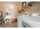 Functional laundry room with overhead cabinets, bench, washer, and dryer at 291 E Canyon Rock Rd, San Tan Valley, AZ 85143