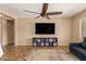 Spacious living area with a large TV, stylish storage, ceiling fan, and cozy rug at 291 E Canyon Rock Rd, San Tan Valley, AZ 85143