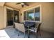 Covered patio with outdoor dining set and ceiling fan for relaxation and entertaining at 291 E Canyon Rock Rd, San Tan Valley, AZ 85143