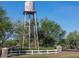A water tower for Johnson Ranch in a well-maintained community with beautiful trees and landscaping at 291 E Canyon Rock Rd, San Tan Valley, AZ 85143