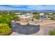 Aerial shot of desert home highlighting the driveway, three car garage, and well-maintained desert landscaping at 29619 N 142Nd Pl, Scottsdale, AZ 85262