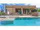 Beautiful backyard with a pool, covered patio, and lush landscaping, perfect for outdoor entertaining and relaxation at 29619 N 142Nd Pl, Scottsdale, AZ 85262