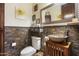 A bathroom is equipped with a vessel sink, wood vanity, and tiled accent wall at 29619 N 142Nd Pl, Scottsdale, AZ 85262