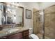 This bathroom features granite countertops, wood cabinets, and a walk-in shower at 29619 N 142Nd Pl, Scottsdale, AZ 85262