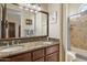 Bathroom featuring a double sink vanity with granite countertops, creating a luxurious and functional space at 29619 N 142Nd Pl, Scottsdale, AZ 85262