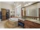 This bathroom features a chandelier, soaking tub, and stone countertops at 29619 N 142Nd Pl, Scottsdale, AZ 85262
