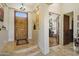 Entryway featuring high ceilings, travertine floors, and custom wood door at 29619 N 142Nd Pl, Scottsdale, AZ 85262