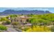 Two story home with desert landscaping and mountain views in a residential community at 29619 N 142Nd Pl, Scottsdale, AZ 85262
